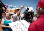 Joe Stapleton, center, and Neill Wilkerson, right, exchange words during at the courthouse in Granbury, Texas, on Thursday, July 2, 2015, amid dueling same-sex marriage rallies.
