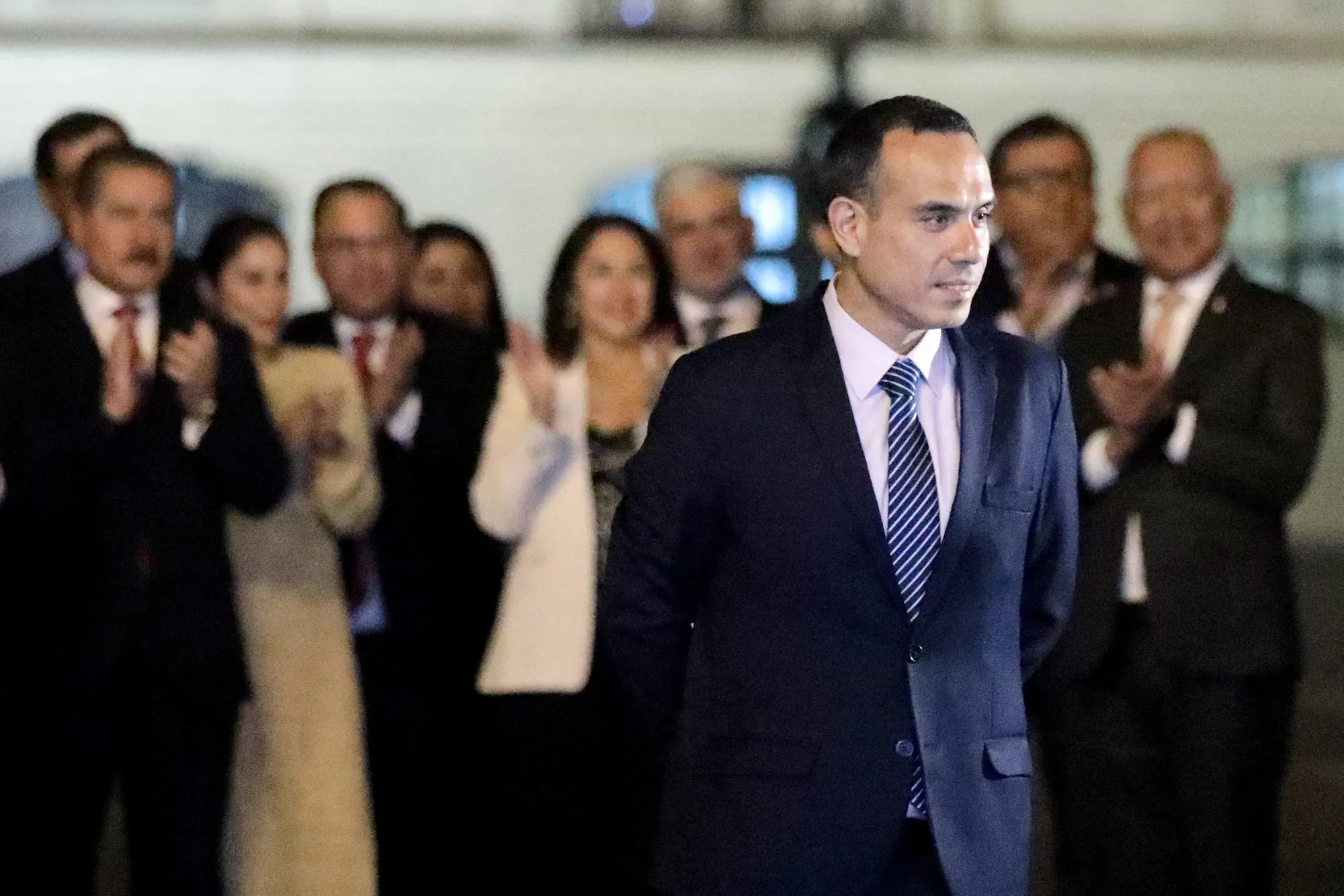 Jose Jeri walks out of the Government Palace as his cabinet applauds him in Lima on Feb. 17.&nbsp;