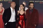 From left, cast members Dwayne Johnson, Gal Gadot and Ryan Reynolds arrive at the Los Angeles premiere of &quot;Red Notice&quot; at L.A. Live on Wednesday, Nov. 3, 2021. (Photo by Jordan Strauss/Invision/AP)