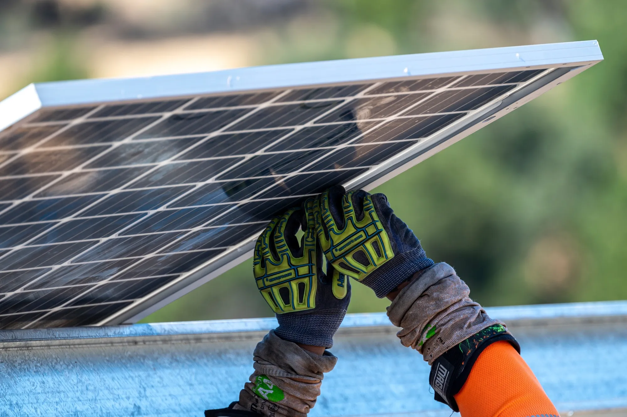 Contractors install solar panels.