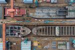 Ships stand under construction in this aerial photograph taken above the Hyundai Heavy Industries Co. shipyard in Ulsan, South Korea, on Wednesday, July 29, 2015. Hyundai Heavy is one of South Korea's Big Three shipbuilders.
