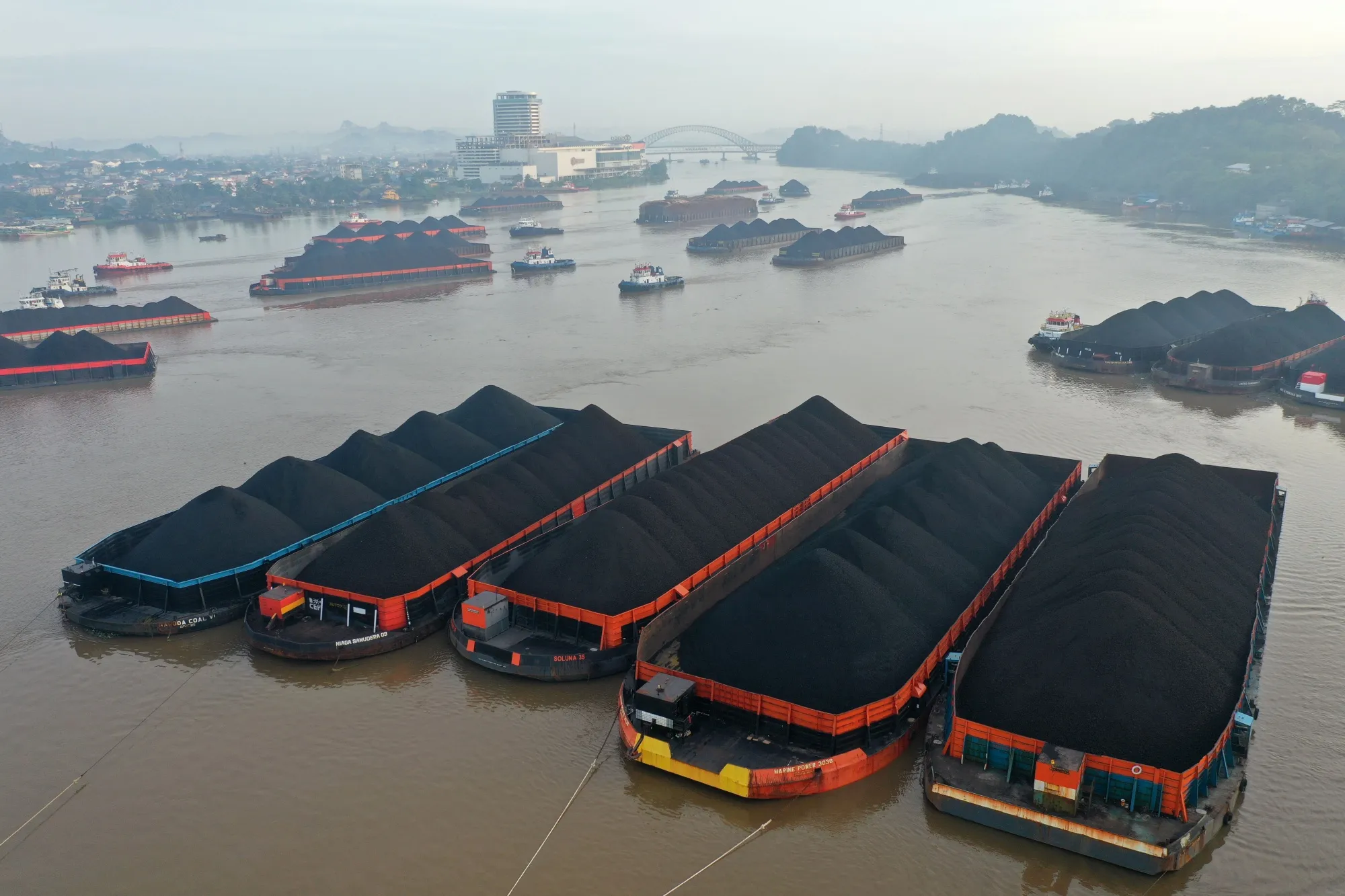 Barges transporting coal are moored on the Mahakam River in Samarinda, East Kalimantan, Indonesia.