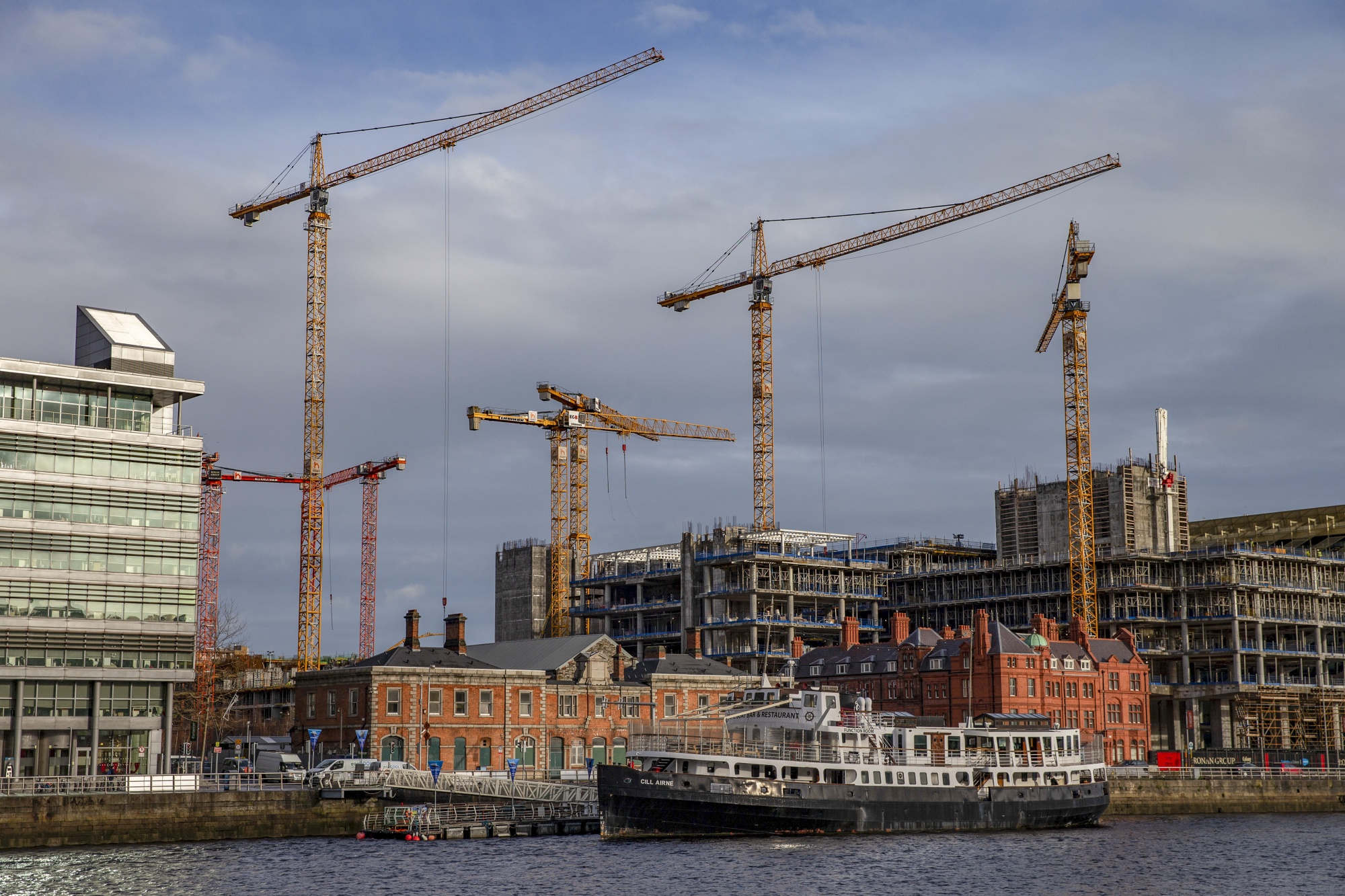 Construction cranes line the River Liffey near North Dock, Dublin, Ireland, on Monday, Jan. 6, 2020.&nbsp;