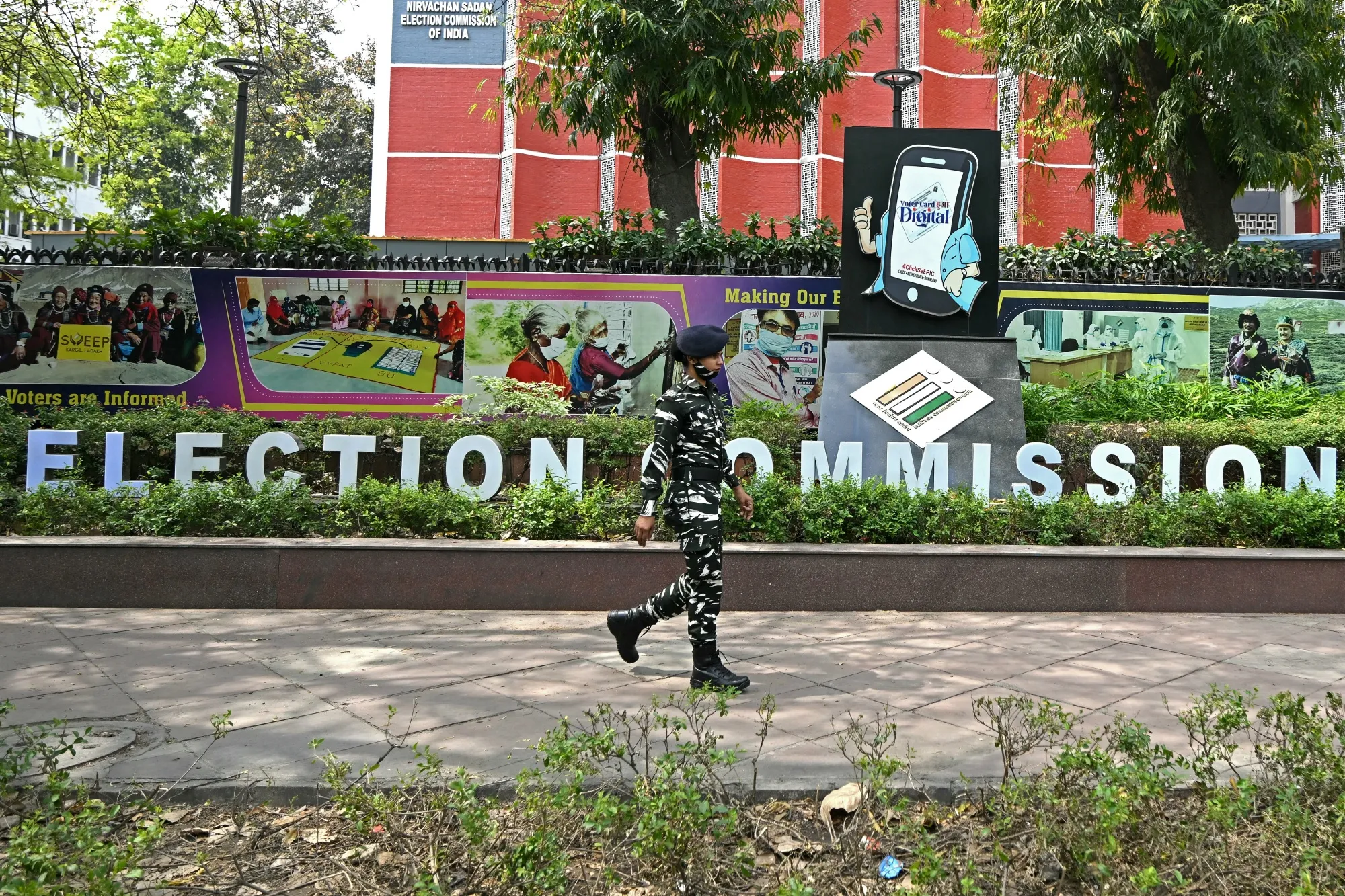 An Indian security personnel walks past the office of the Election Commission of India in New Delhi.