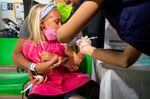 A healthcare worker administers a dose of the Moderna Covid-19 vaccine to a 4-year-old child in the Brooklyn borough of New York, US.