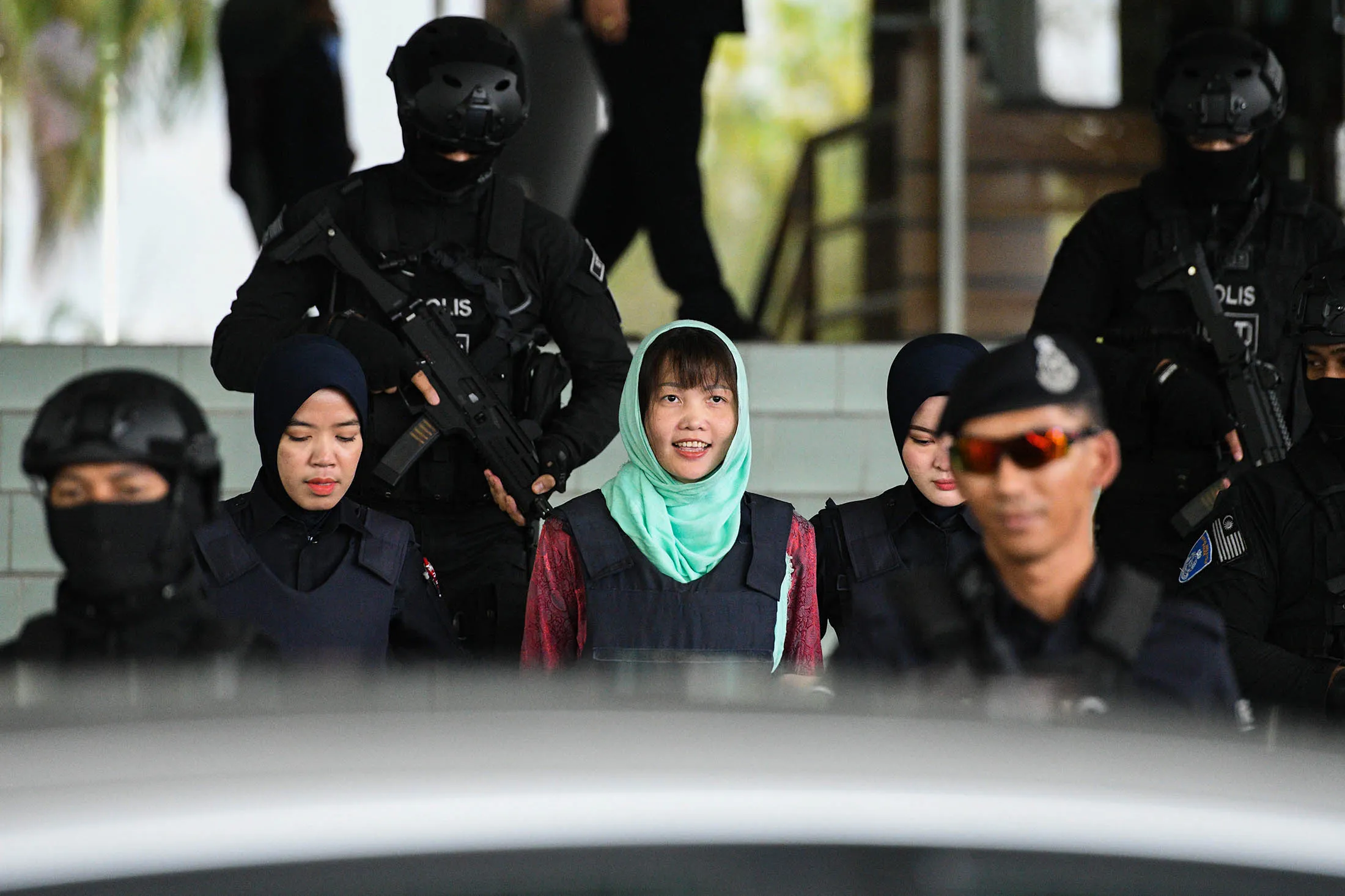 Doan Thi Huong is escorted by Malaysian police out of the High Court in&nbsp;April 2019.