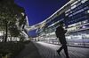 A pedestrian walks past the illuminated Sky Soho building, which houses the headquarters of Ctrip.com International Ltd., at night in Shanghai, China, on Monday, Jan. 23, 2017. Ctrip is the world's No. 2 online agency by market value.