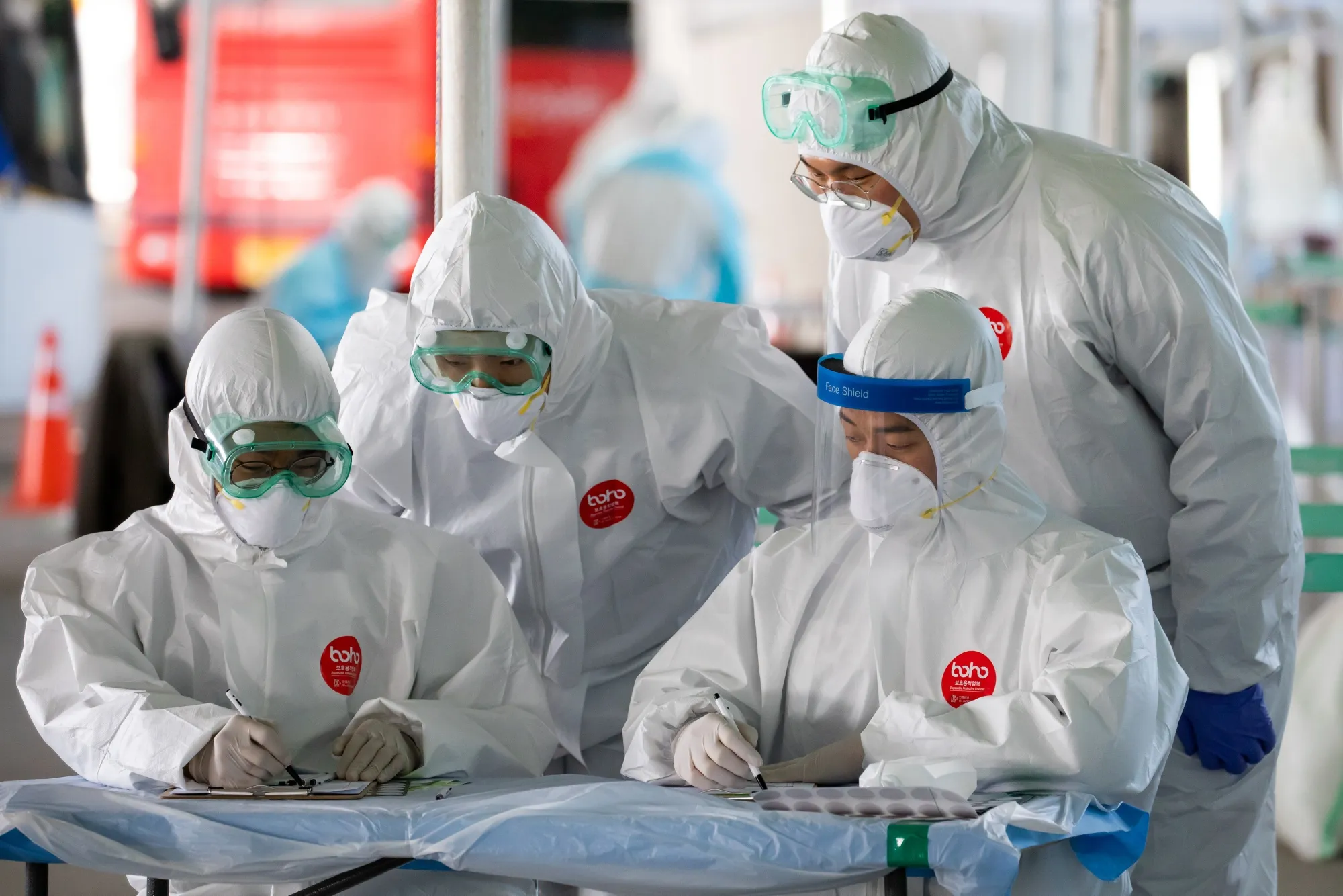 Medical staff in protective gear work at a coronavirus testing station&nbsp;in Incheon, South Korea.&nbsp;