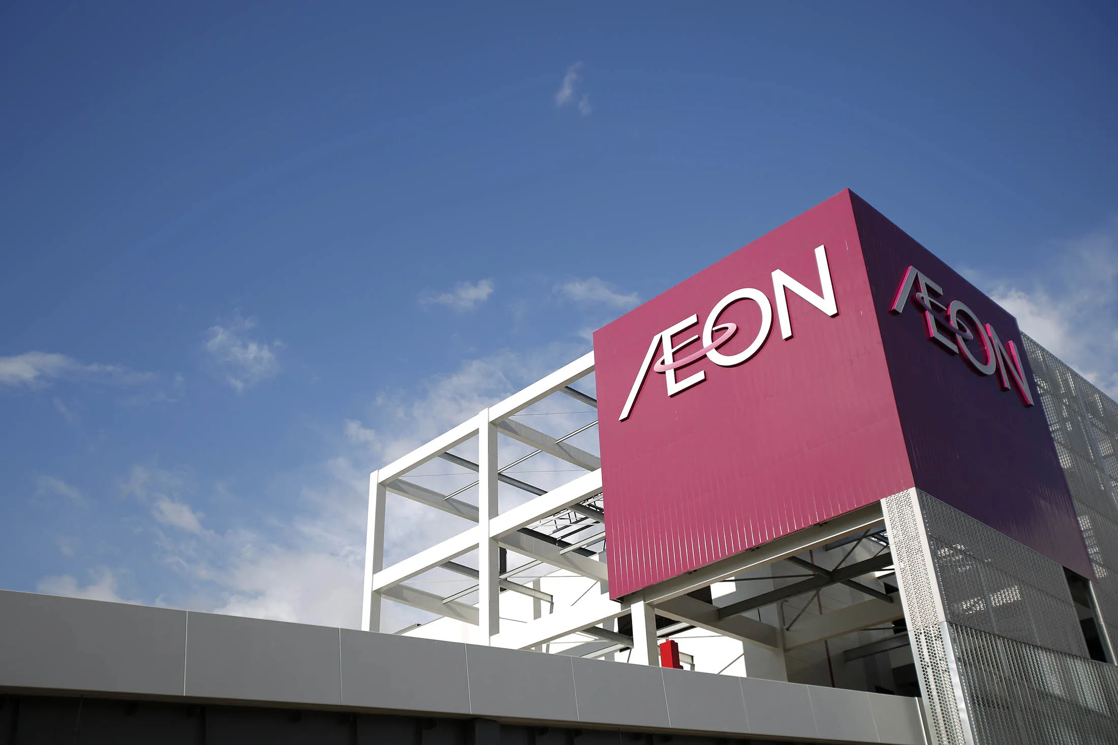 Signage for Aeon Co. is displayed atop the Aeon Mall Makuhari Shintoshin shopping mall, operated by Aeon Mall Co., in Chiba, Japan, on Monday, Dec. 20, 2013.
