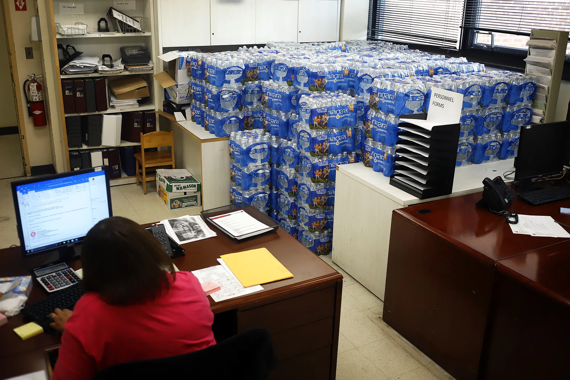 Water is stacked and scattered around the Newark Health Department on Aug. 14.