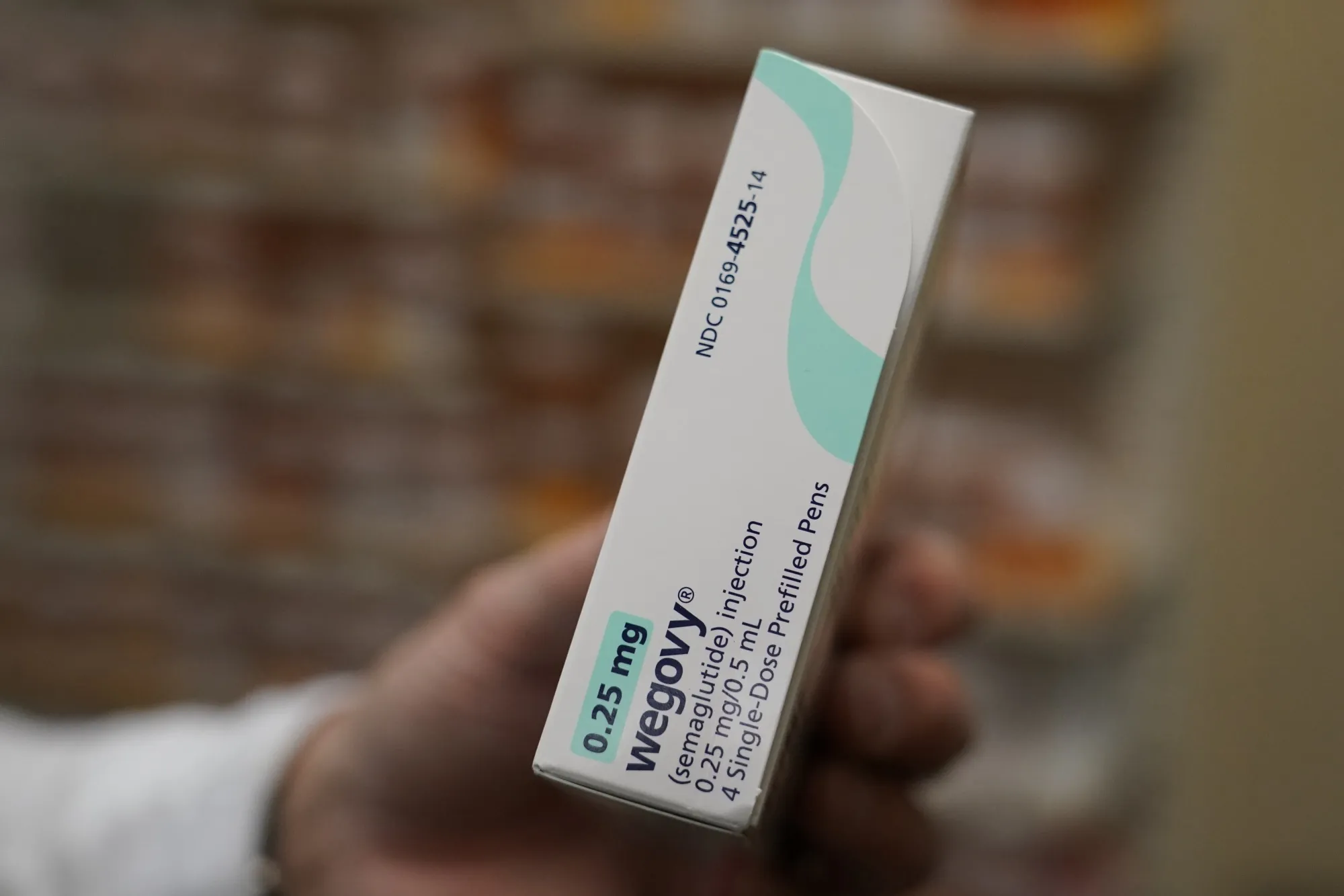 A pharmacist holds a box of Novo Nordisk A/S Wegovy brand semaglutide medication.&nbsp;