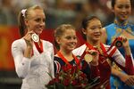 Nastia Liukin, left, and teammate Shawn Johnson, center, hold their medals during the 2008 Olympics. Both still have staying power thanks to Instagram and other platforms.