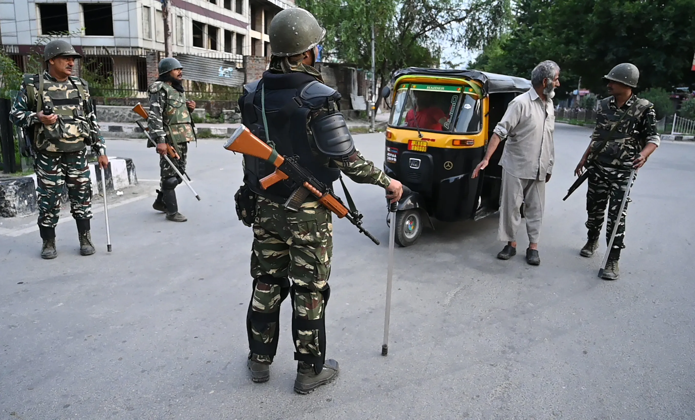 Security personnel stop a man for questioning during a lockdown in Srinagar on Aug. 12.
