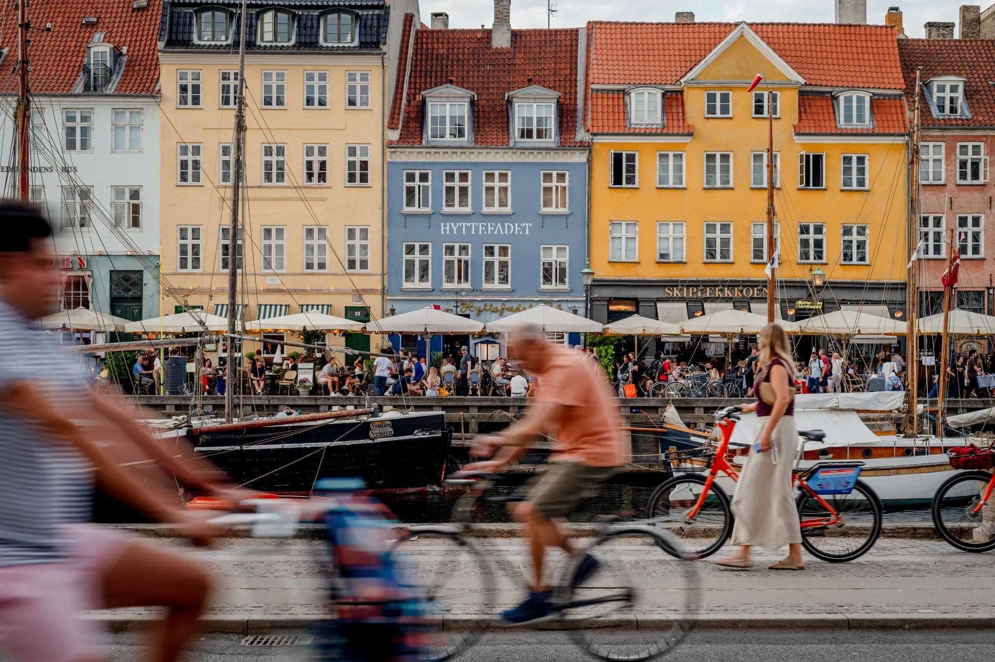 Restaurant terraces in the popular tourist location of Nyhavn Harbour in Copenhagen.