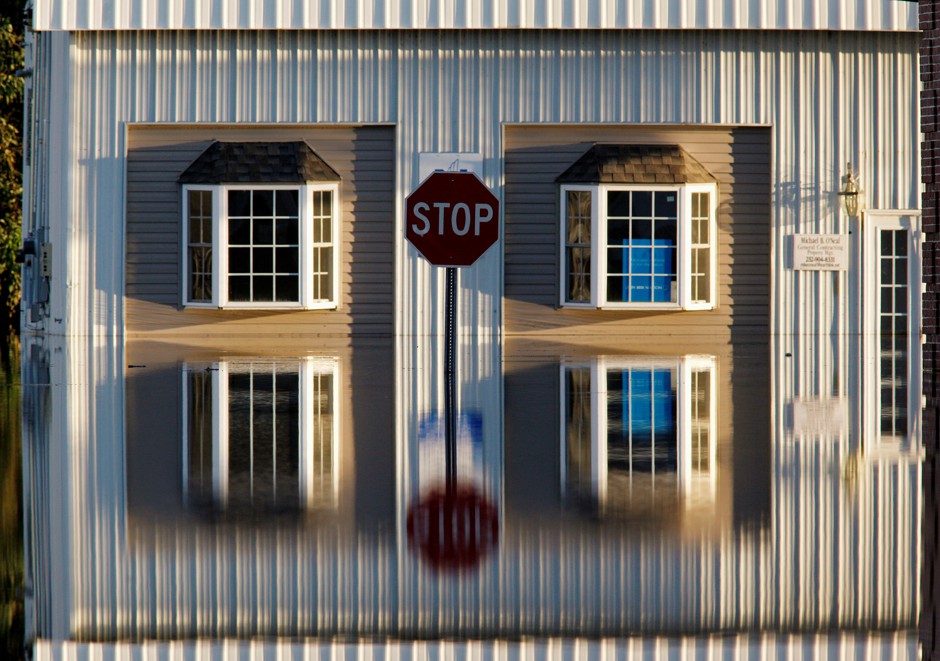 A building and street signs in Tarboro, North Carolina, are reflected in flood waters in the aftermath of Hurricane Matthew on October 13, 2016.