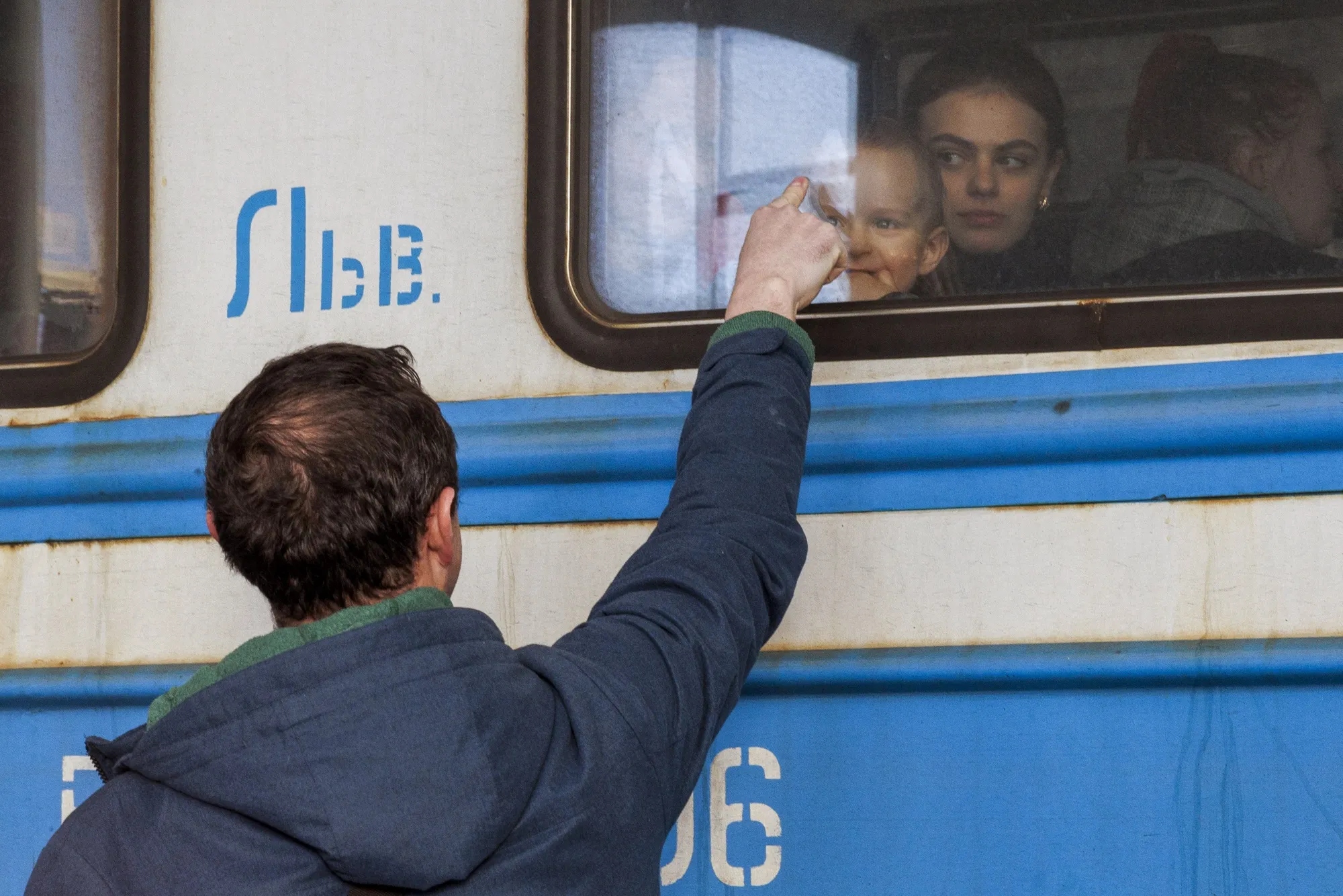 A Ukrainian father bids farewell to his son aboard a train in Lviv, Ukraine, on&nbsp;March 14. Russian shelling of the capital, Kyiv, and other cities has killed thousands of Ukrainian civilians, local officials said, though the numbers couldn’t be confirmed. United Nations officials put the confirmed death toll at about 900, but add that the real&nbsp;number is likely much higher.