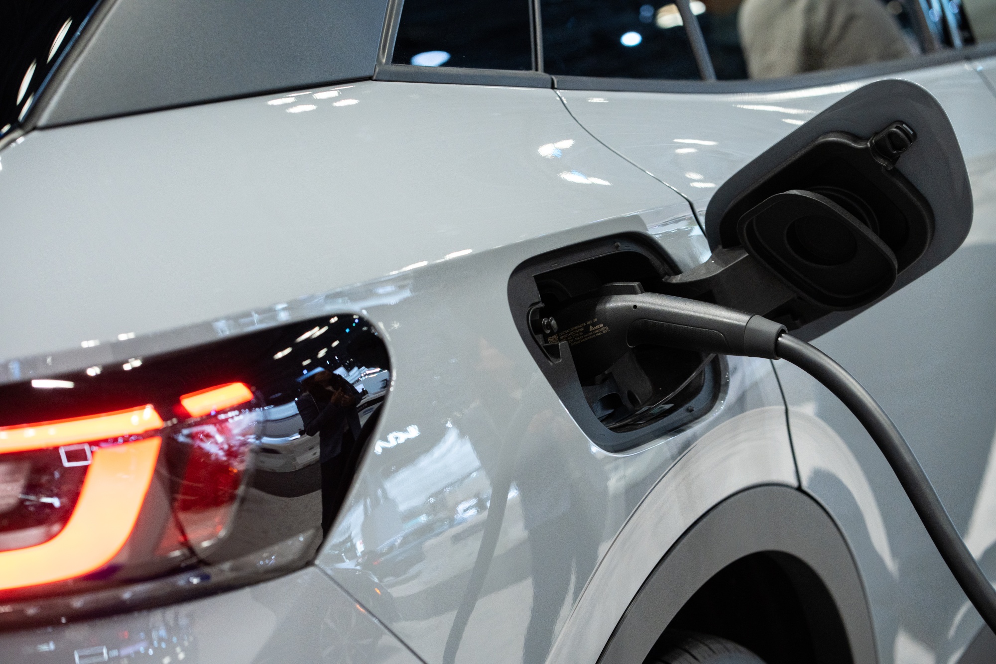 The charging port of a Volkswagen ID.4 electric sports utility vehicle (SUV) during the 2022 New York International Auto Show (NYIAS) in New York, U.S., on Thursday, April 14, 2022. The NYIAS returns after being cancelled for two years due to the Covid-19 pandemic.