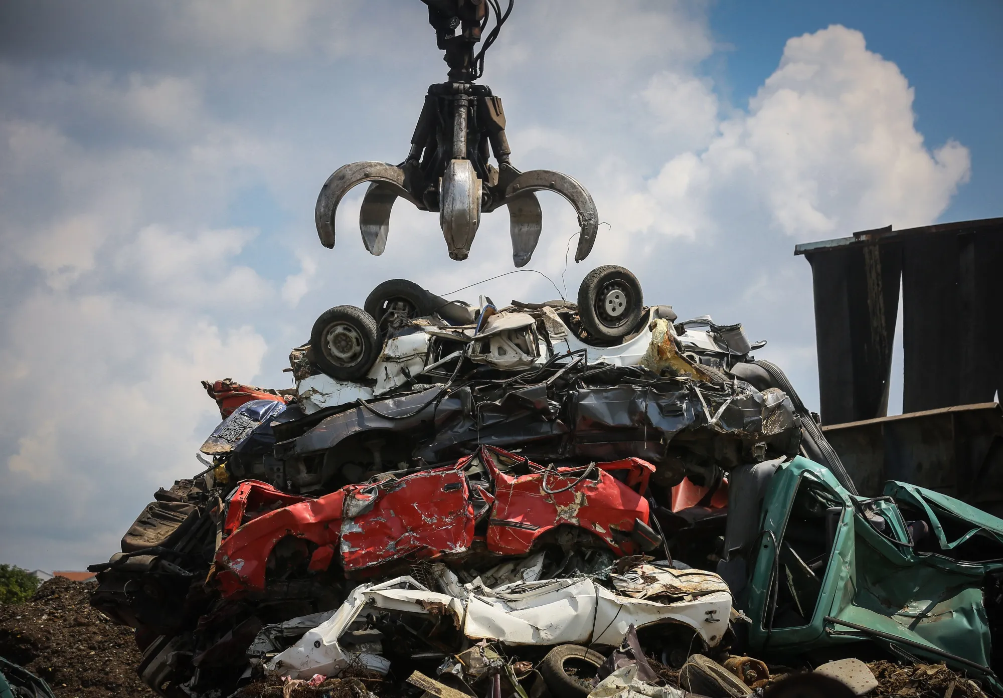 Cars Being Being Broken At A Vehicle Scrapyard