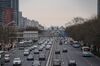 Vehicles travel along Chang'an Avenue in Beijing, China, on Saturday, March 6, 2021. China, the world's biggest car market, aims to boost auto sales and add more charging facilities for electric vehicles this year.