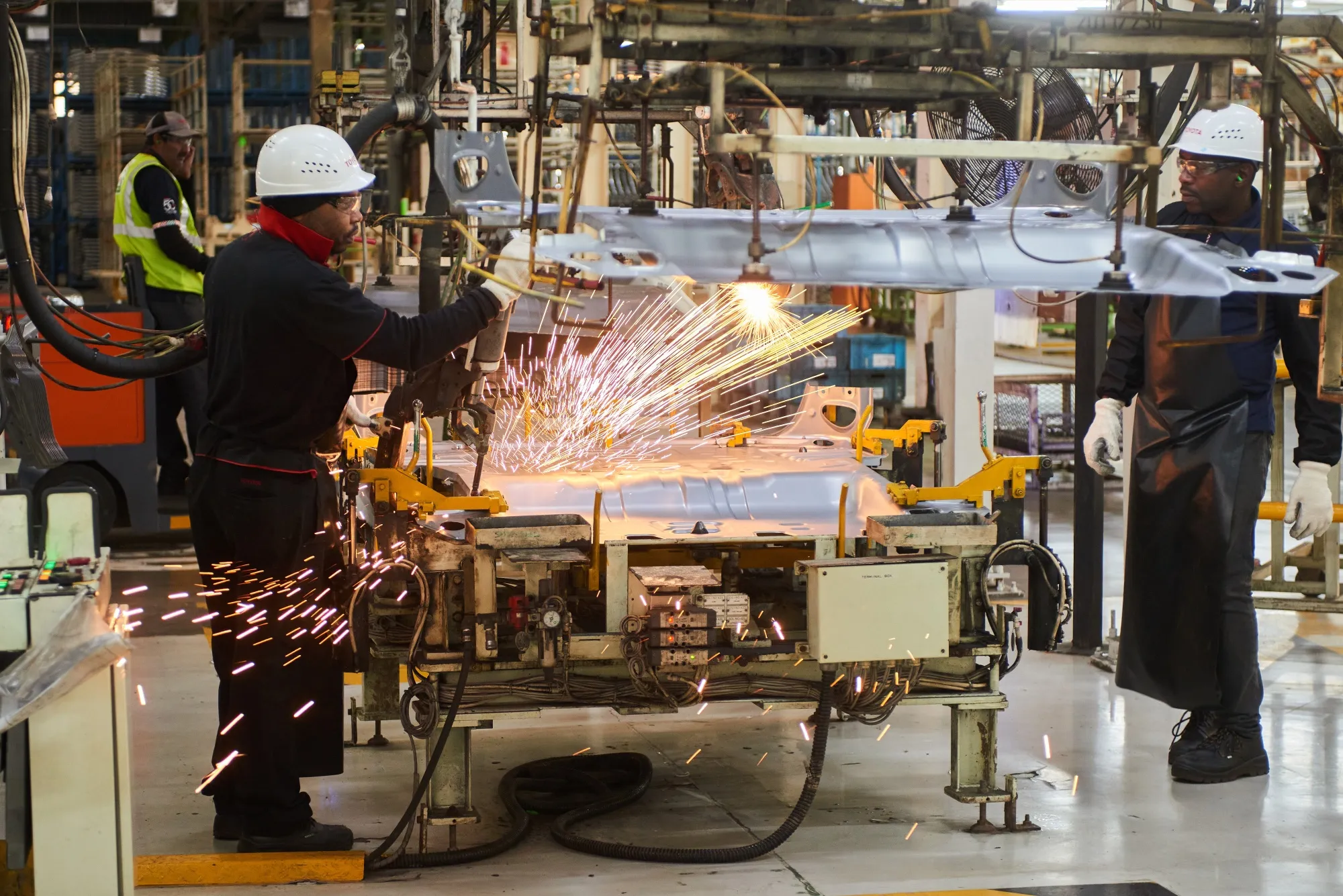 Workers weld automobile panels at a factory in Durban, South Africa.