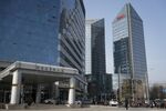 The HNA Group Co. building, right, stands in Beijing, China.