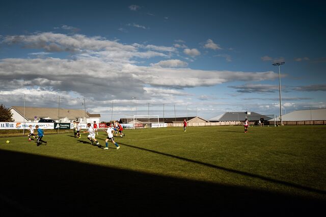 Children play football at Froya Storhall football facility, built through a partnership with the municipality and the island's salmon industry.