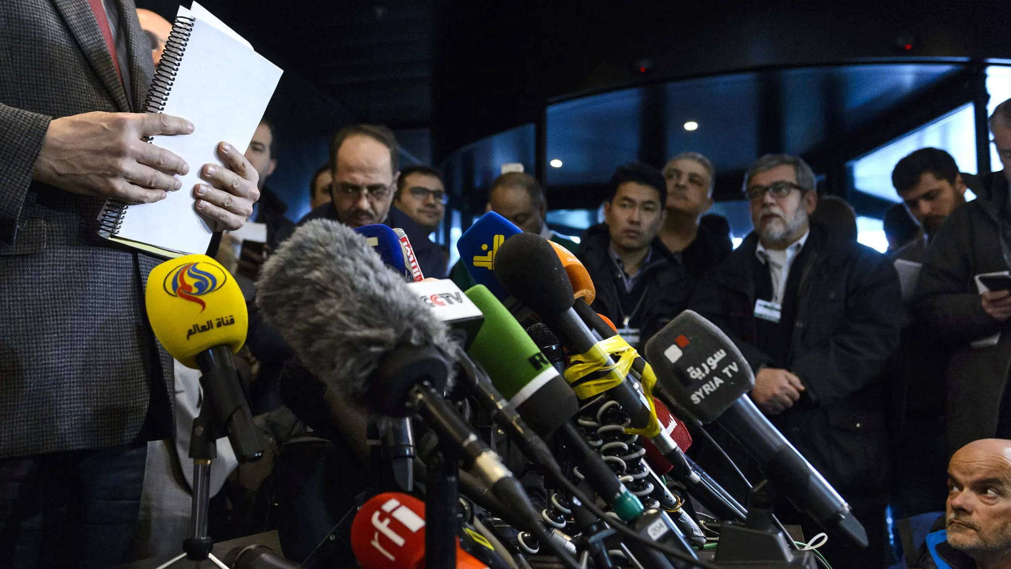 Syrian Ambassador to the UN and head of the government delegation holds documents during a press conference held at the Syria peace talks in Geneva.
