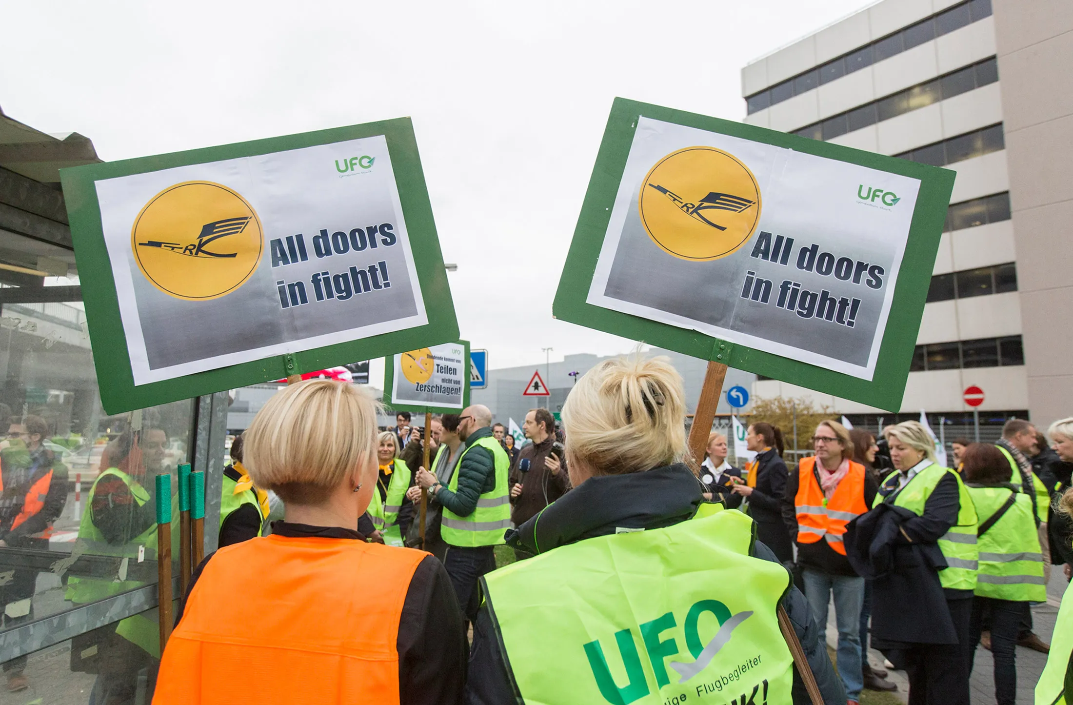 Striking Deutsche Lufthansa AG cabin crew members hold placards during industrial action outside Frankfurt Airport
