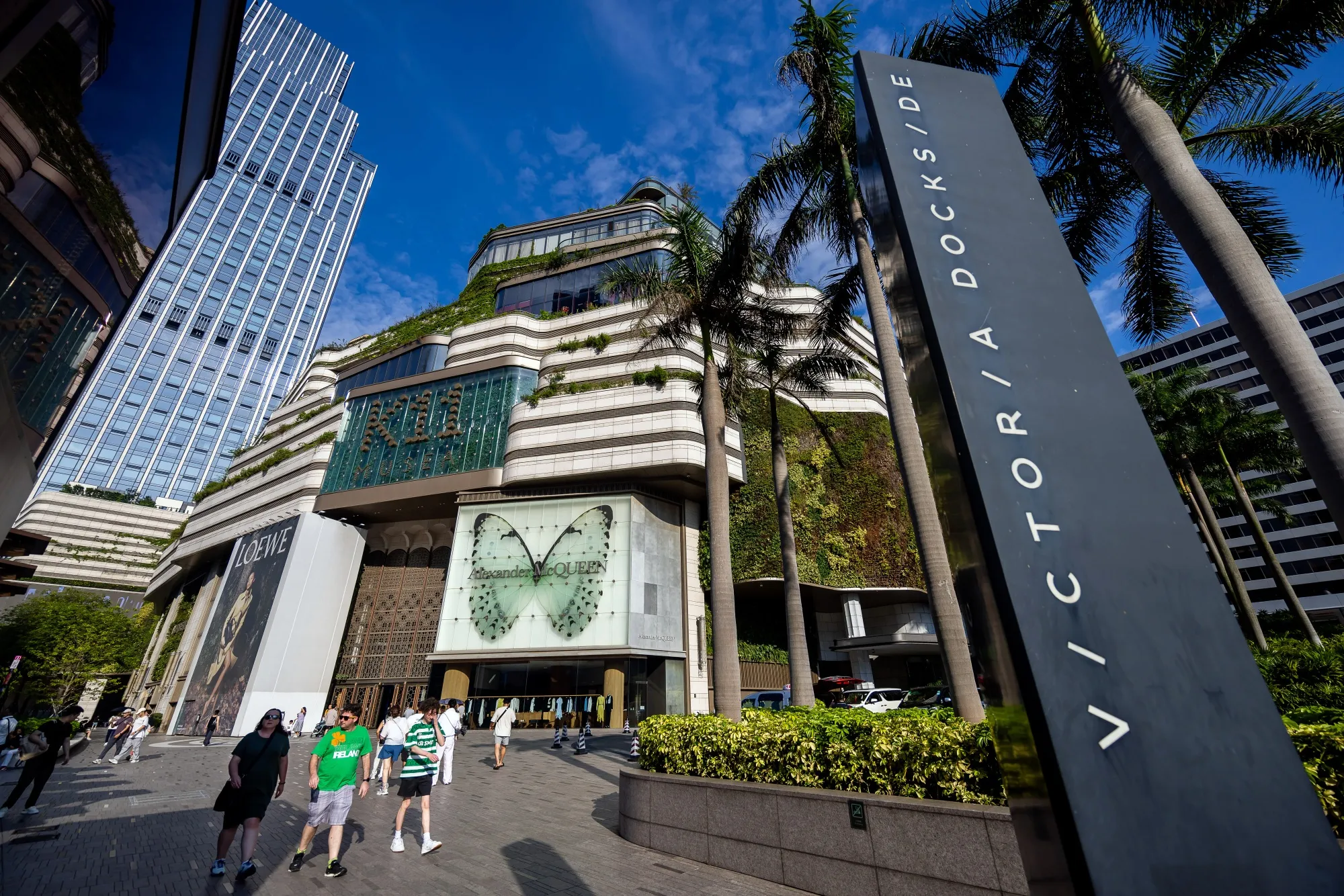 Signage at the Victoria Dockside commercial complex, developed by New World Development, in Hong Kong on Friday, July 4, 2025.