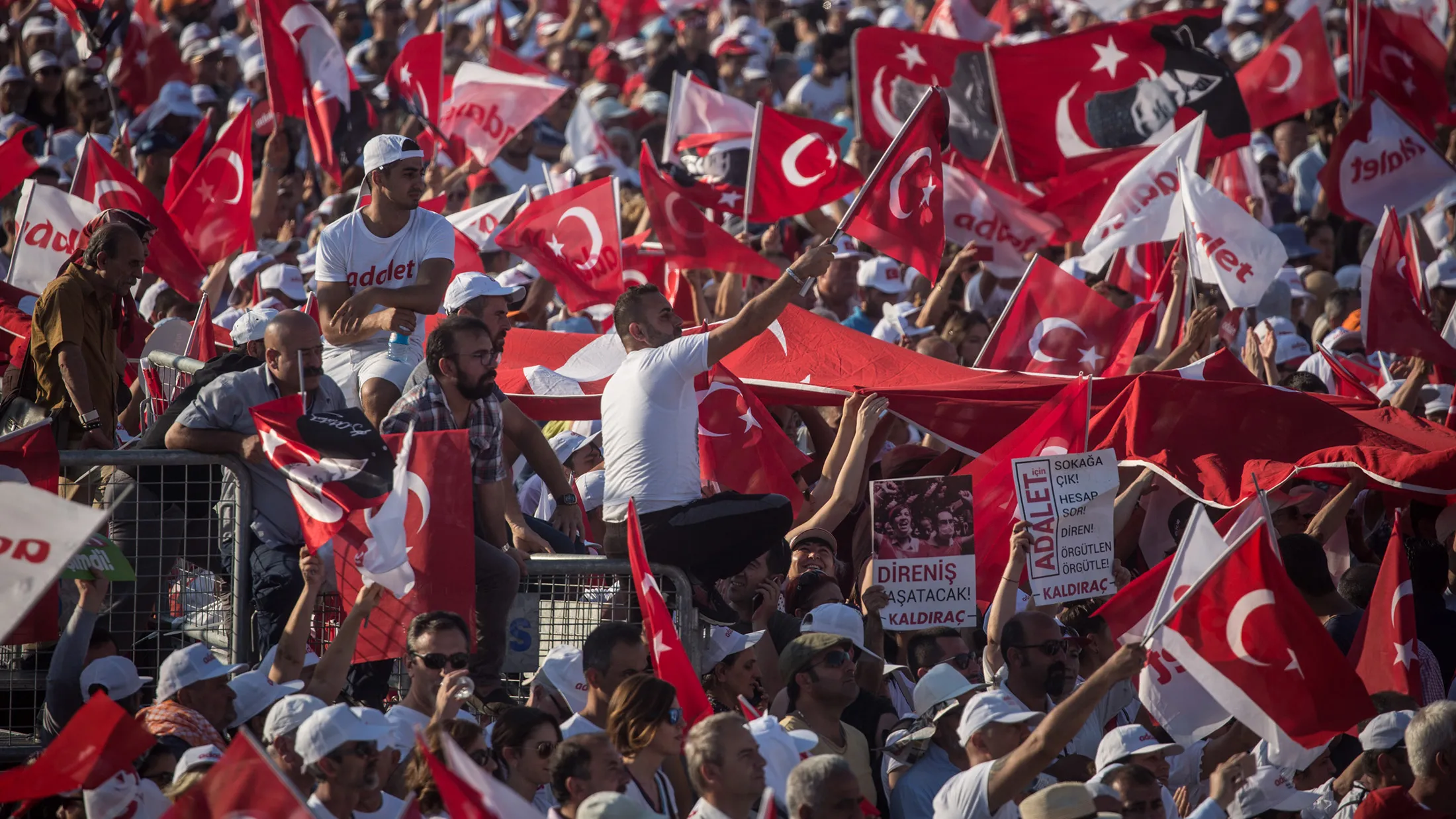 ISTANBUL, TURKEY - JULY 09: Thousands of supporters cheer and wave flags while listening to Turkey's main opposition Republican People's Party (CHP) leader Kemal Kilicdaroglu speak on stage during the 'Justice Rally' on July 9, 2017 in Istanbul, Turkey. The Justice Rally was held to conclude the 25 day 'Justice March' led by Kemal Kilicdaroglu which saw thousands of people march 425-kilometers from Ankara to Istanbul. The march and the rally were held to protest the conviction of CHP lawmaker Elis Berberoglu and to support an independent an fair judicial system in Turkey.
