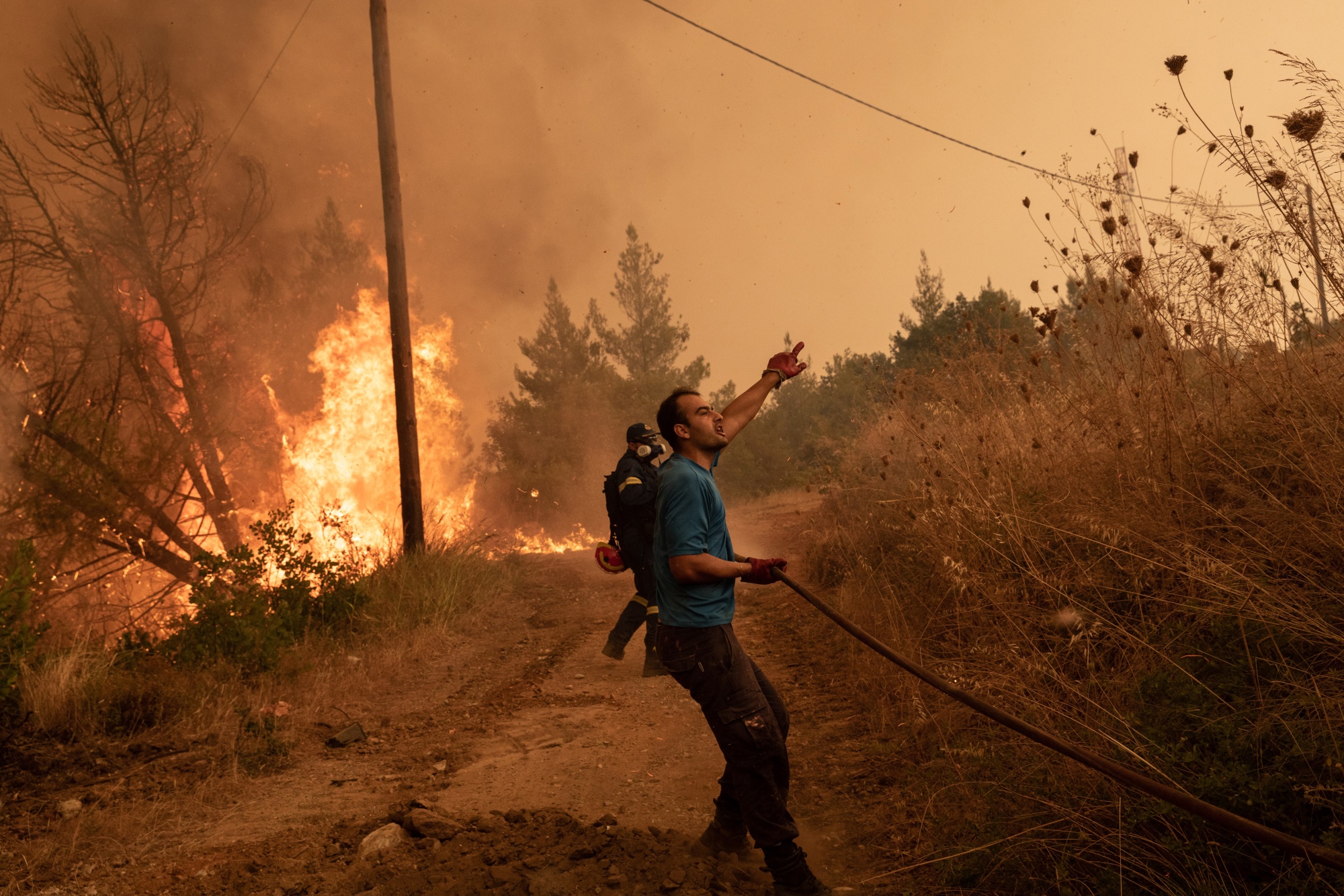 A firefighter douses flames from a wildfire on the island of Evia, Greece, in August.