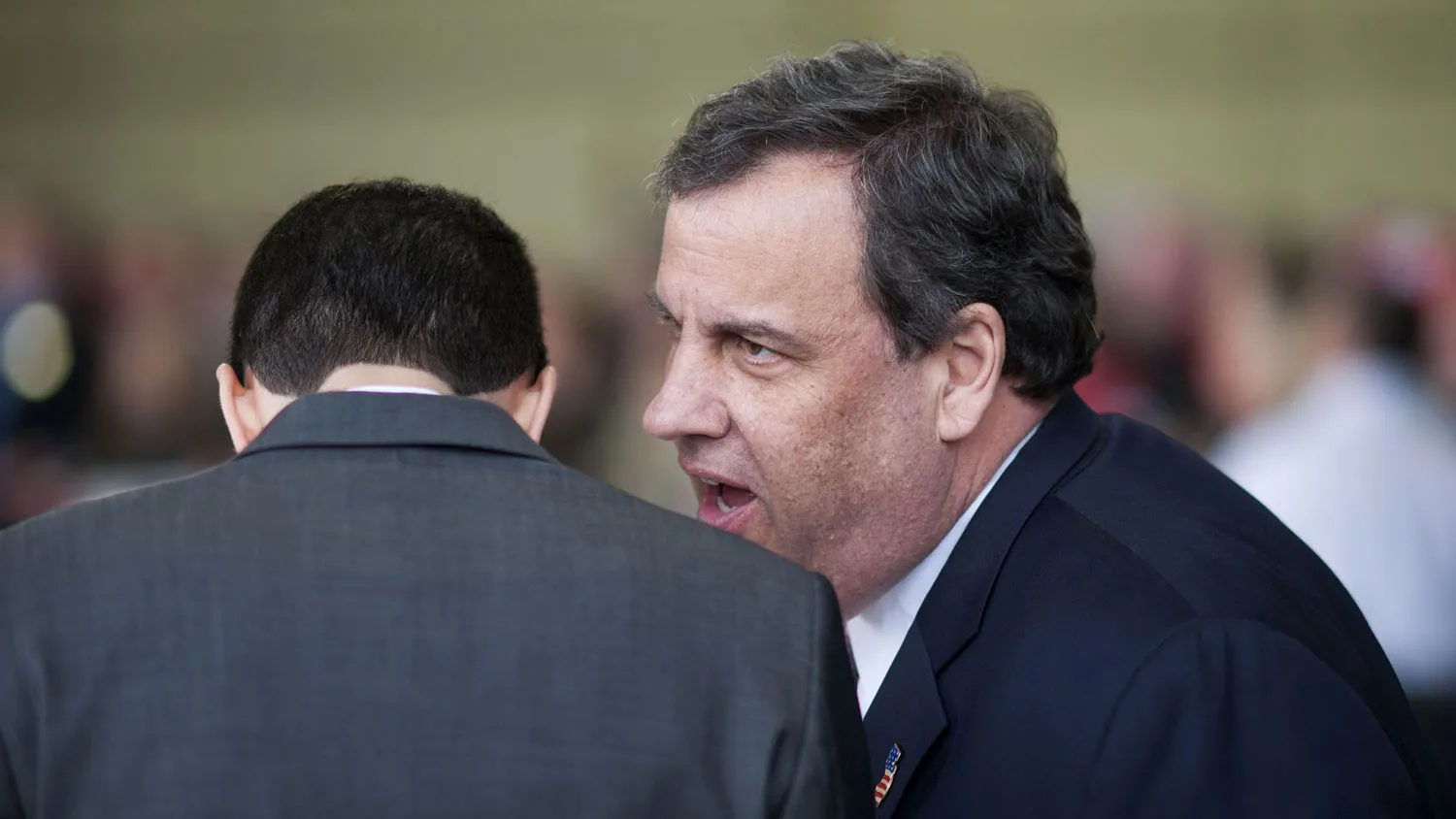 Chris Christie, governor of New Jersey, speaks with an aide at a Donald Trump rally in Columbus, Ohio, on March 1, 2016.
