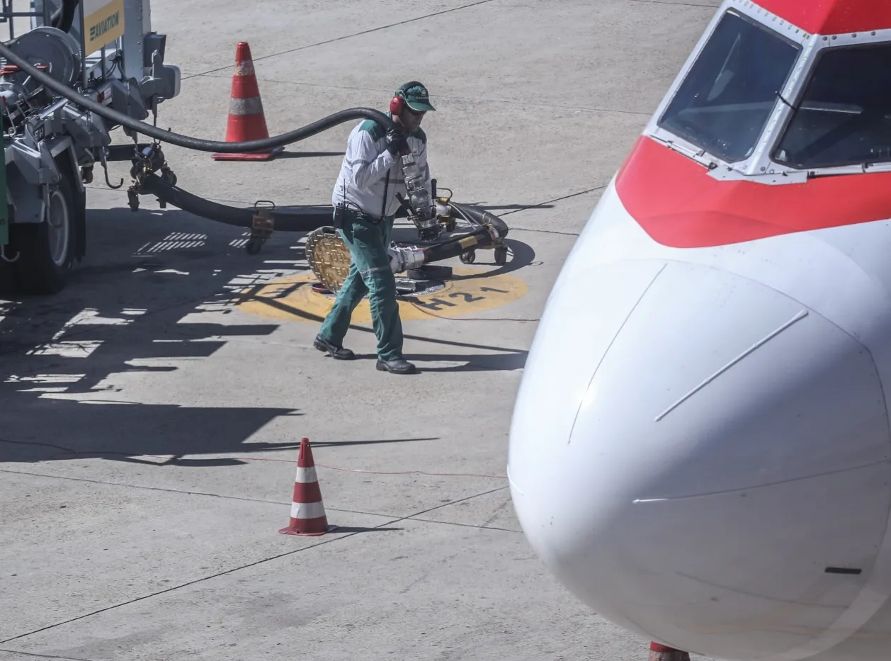 A worker refuels a plane in Brasilia, Brazil.