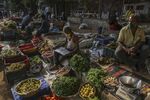 Vegetable vendors wear protective masks while waiting for customers at a market in Mumbai, India, on April 5.