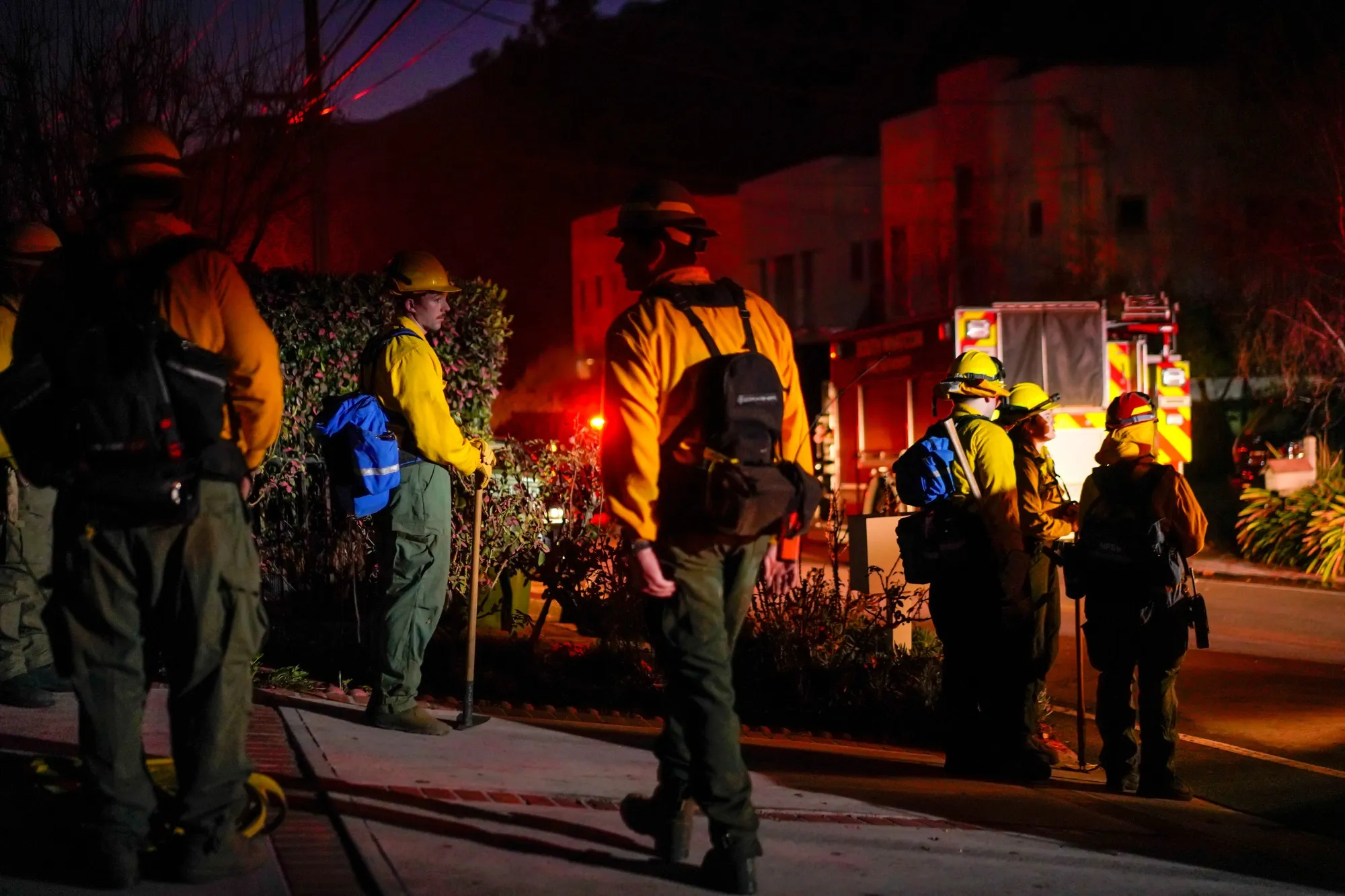 Firefighters work to contain the the Palisades Fire in the Mandeville Canyon on Jan. 12.