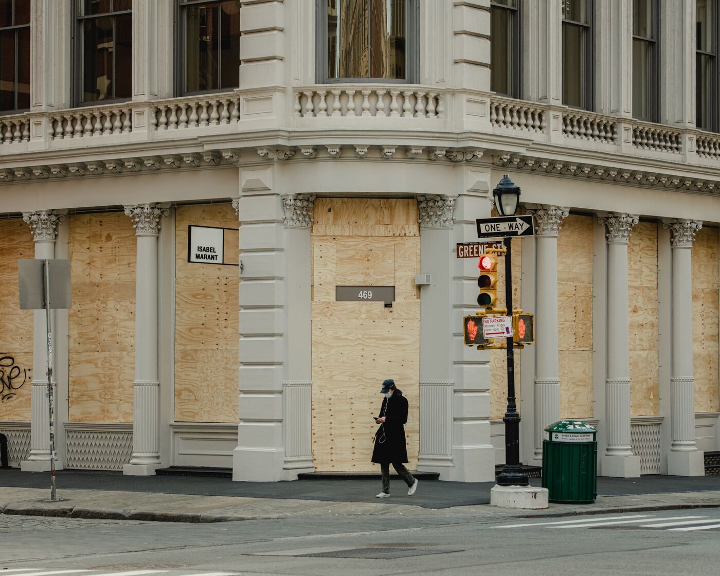 A pedestrian passes a boarded up store in the SoHo neighborhood of New York on April 11.