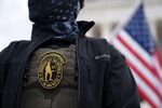 A demonstrator wears an Oath Keepers organization badge on a protective vest during a protest in Washington, DC.
