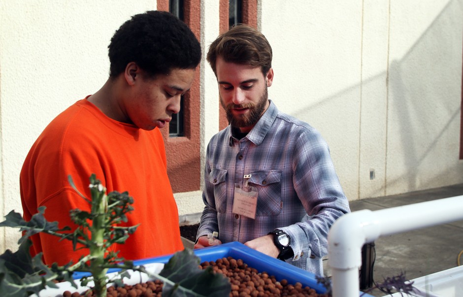 San Francisco County Jail inmate Joseph Herron listens as instructor Tom Bassford explains various water quality tests for their aquaponics project.