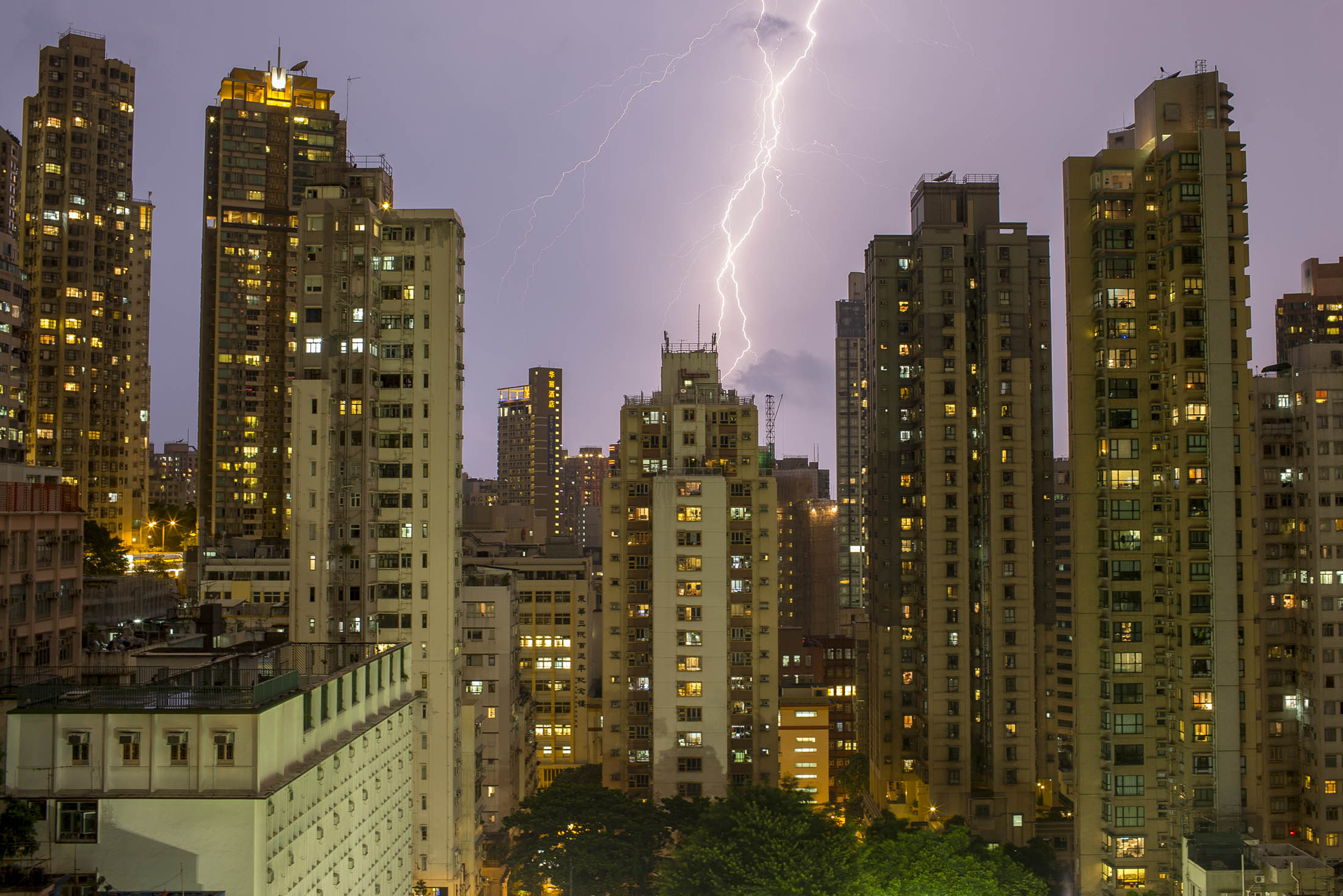 Lightning strikes near residential buildings in the Sheung Wan district of Hong Kong. Hong Kong’s existing-home transactions probably fell to the lowest level in almost 20 years in October as prospective buyers are waiting for prices to drop.
