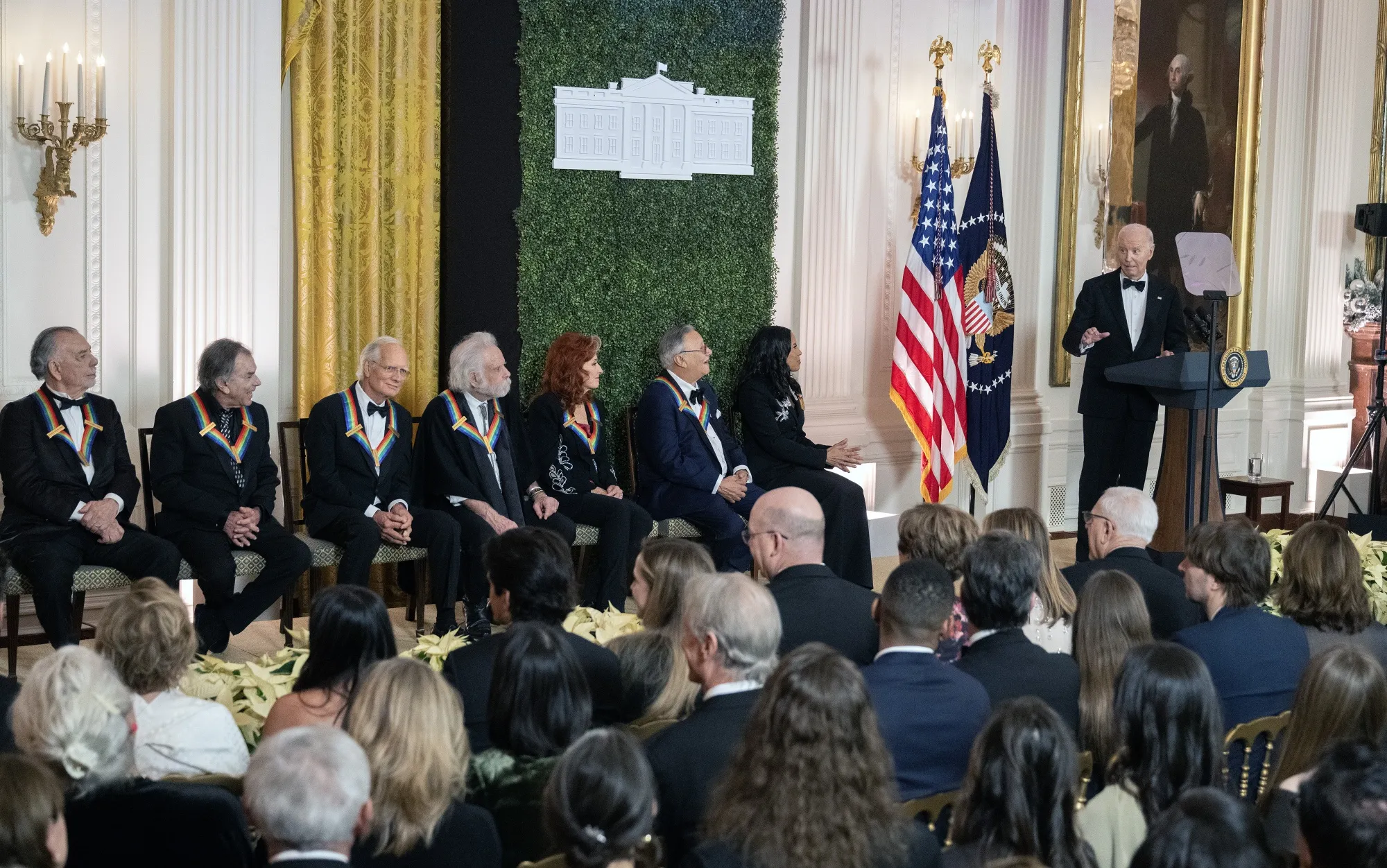 Joe Biden, right, speaks during a ceremony in the East Room of the White House in Washington, DC, on Dec. 8.