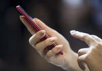 A member of the media tries an Oppo R11s smartphone during a launch event of the smartphone for the Japanese market in Tokyo, Japan, on Wednesday, Jan. 31, 2018.