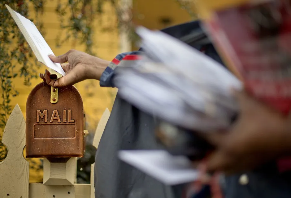 A letter carrier in Atlanta makes a delivery. 