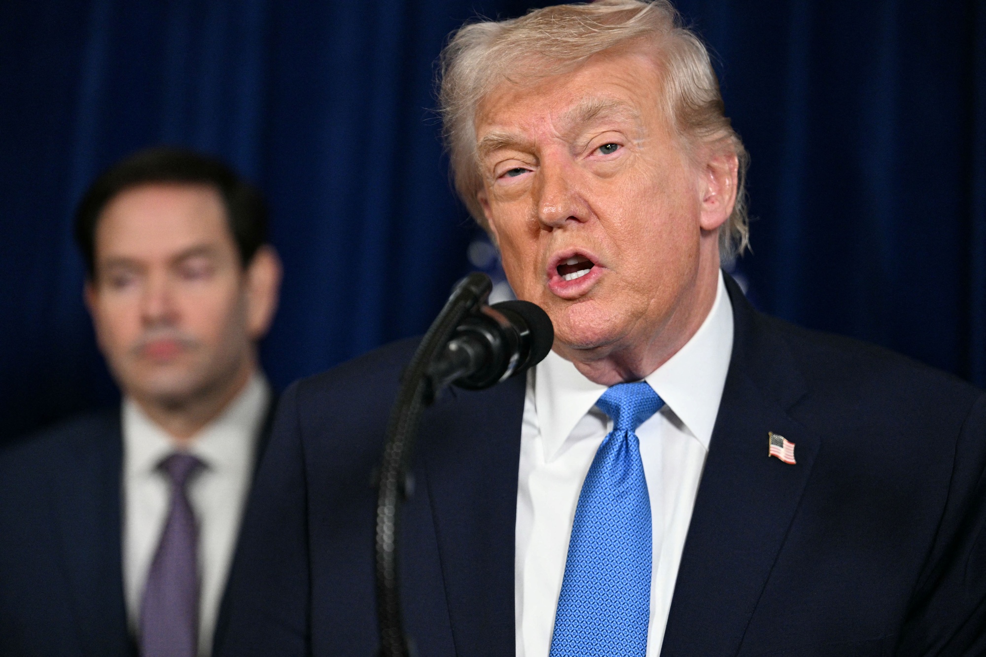 US President Donald Trump speaks to the press as Secretary of State Marco Rubio looks on following US military actions in Venezuela, at his Mar-a-Lago residence in Palm Beach, Florida, on Jan. 3.