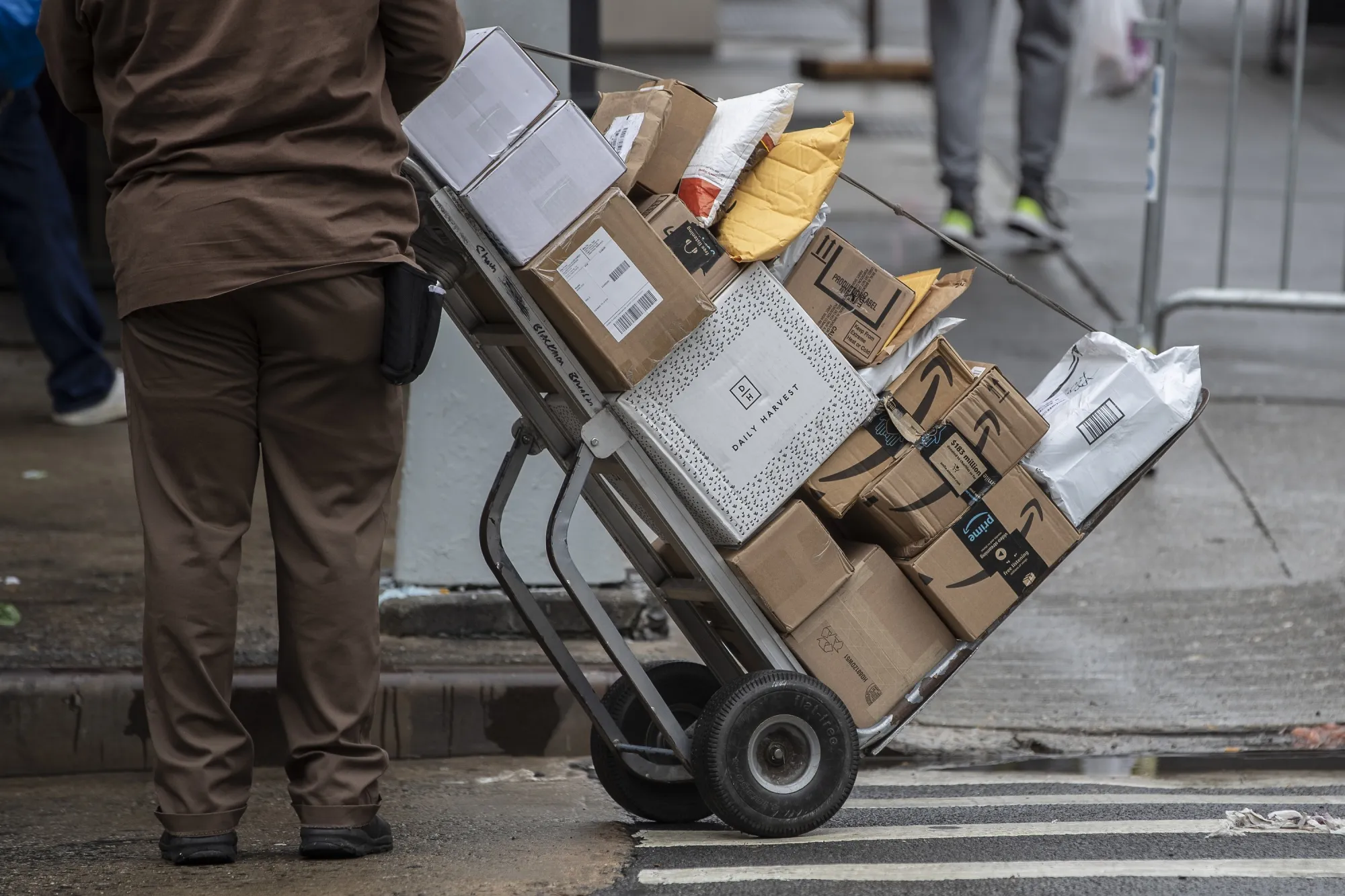 A United Parcel Service driver pushes a trolley laden with boxes in New York City.&nbsp;