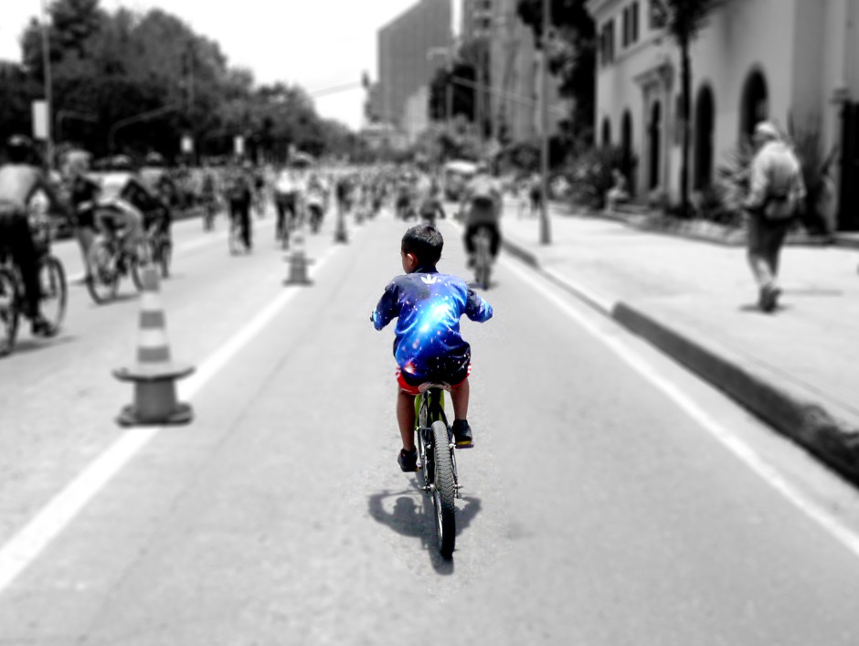 A boy cycles along the Septima during Ciclovía. Normally a chokingly busy thoroughfare, half of the road is closed to traffic every Sunday and holiday.