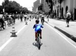A boy cycles along the Septima during Ciclovía. Normally a chokingly busy thoroughfare, half of the road is closed to traffic every Sunday and holiday.