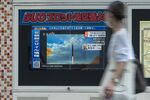 A broadcast showing file footage of North Korean missile launches after the country fired a missile that flew over northeastern Japan, in Tokyo on Oct. 4.