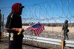 A Central American migrant holds an American flag near&nbsp;along the the US and Mexico border in Tijuana&nbsp;on&nbsp;Nov. 25.&nbsp;