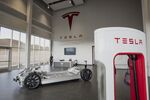 A vehicle charger, right, stands in the lobby at the Tesla Motors Inc. Gigafactory in McCarran, Nevada, U.S.