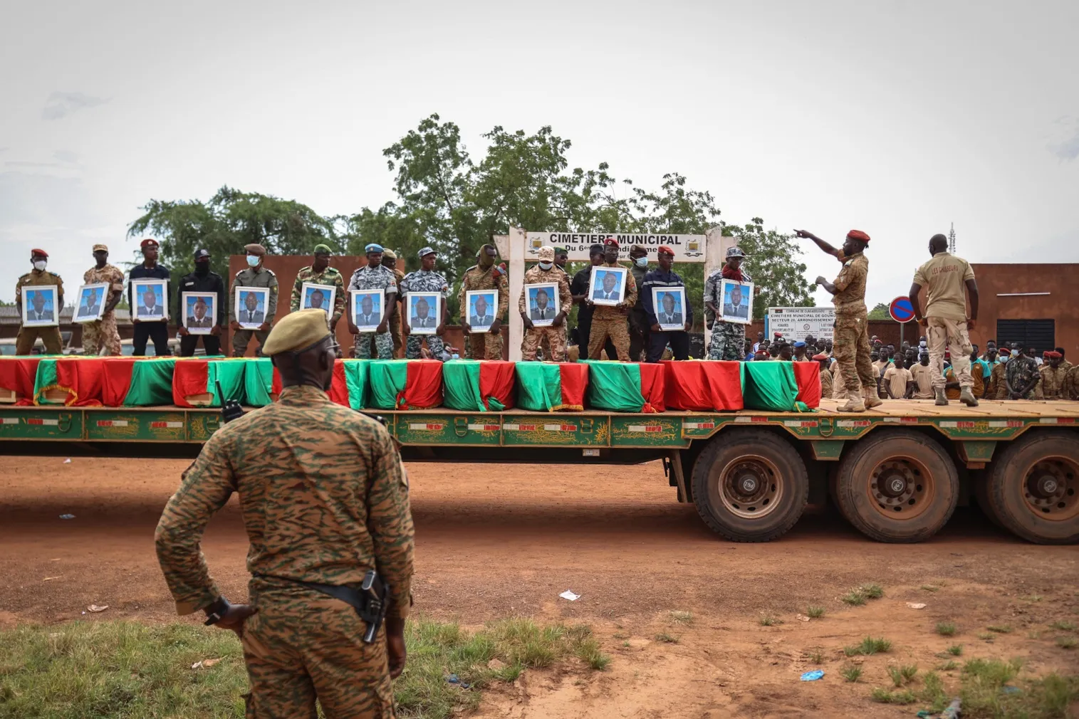 Burkina Faso&nbsp;servicemen hold&nbsp;soldiers' portraits behind coffins during the burial of the soldiers killed in a terrorist attack&nbsp;in Ouagadougou.&nbsp;